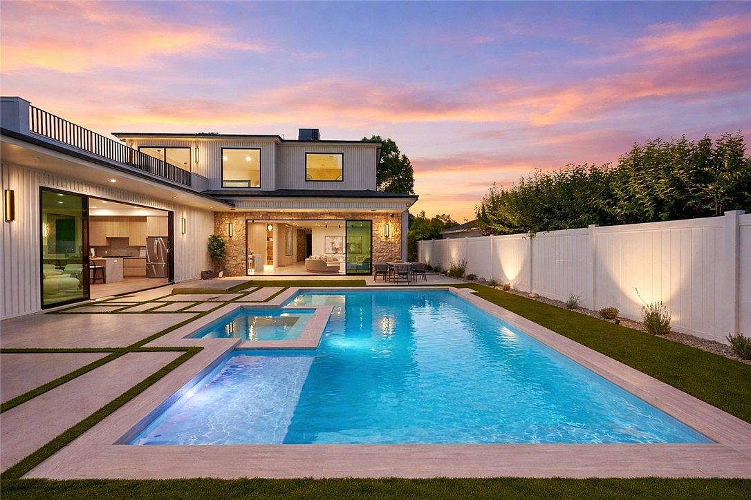 16728 Morrison St — Pool and backyard at sunset with modern farmhouse architecture